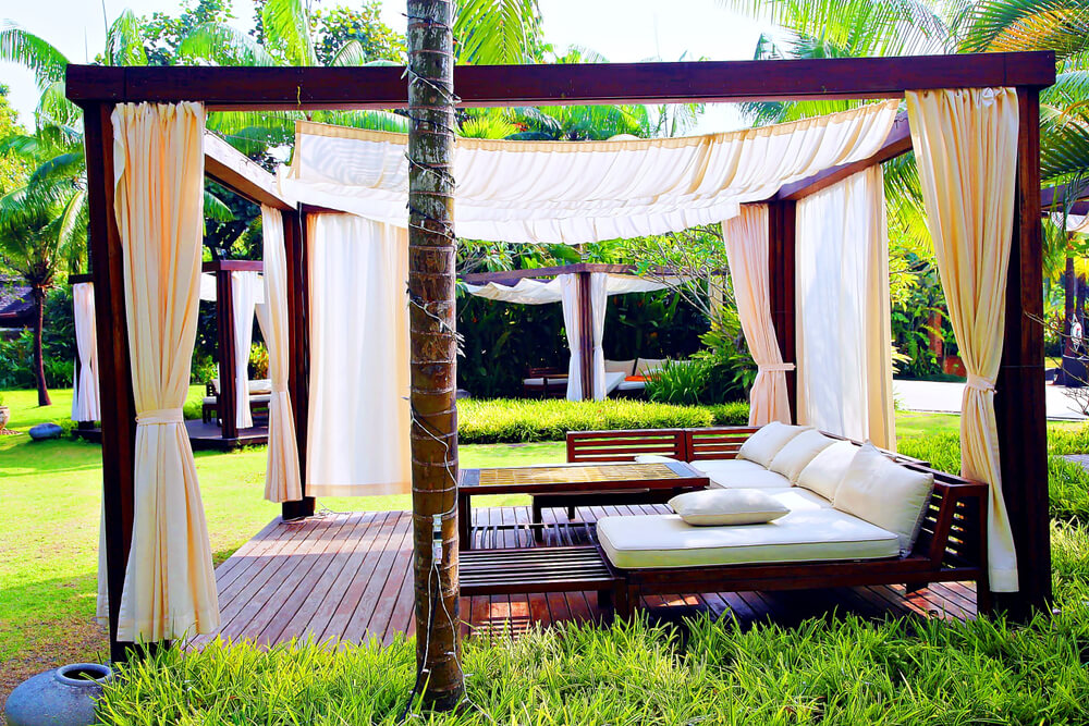 Modern Wooden Beach Pergola With With Curtain ,Table, in Front of the Beach