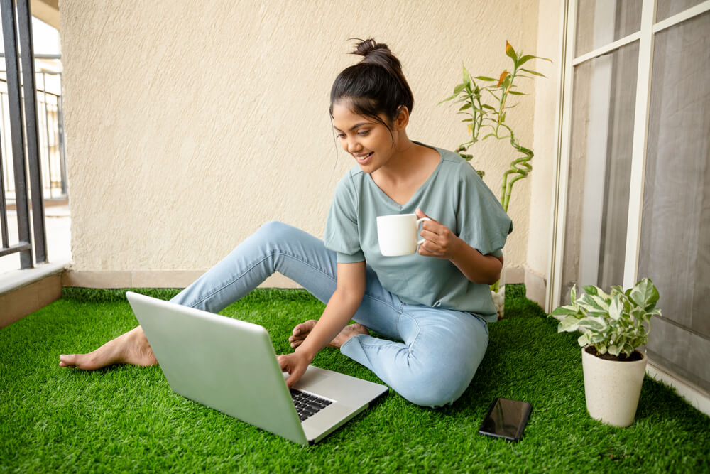 Pretty Young Woman Working on Laptop at Balcony Artificial Grass.