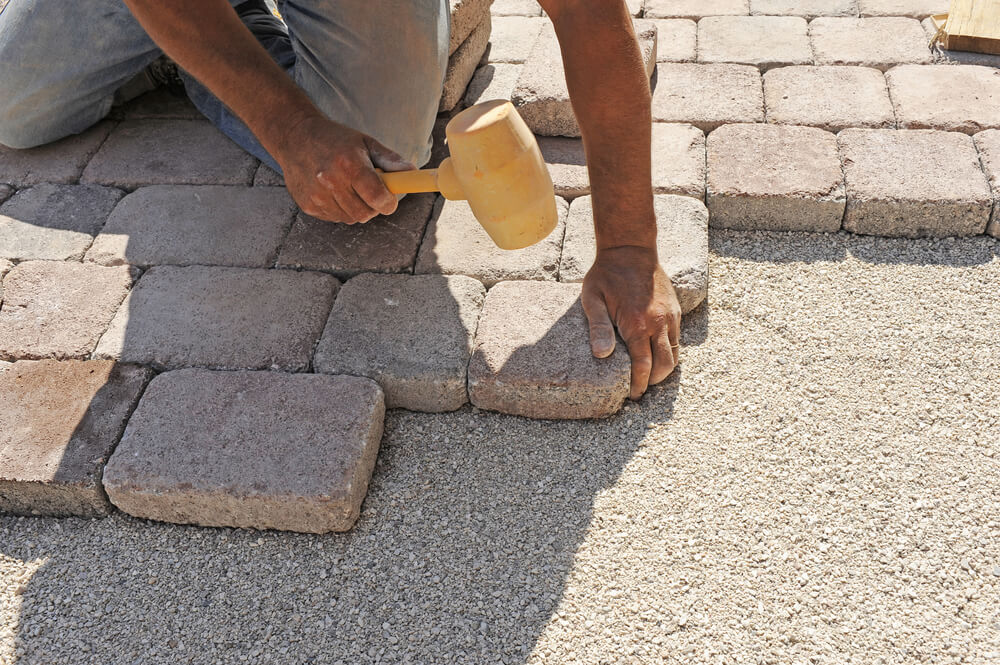 Man at Work Paving Stones With Rectangular