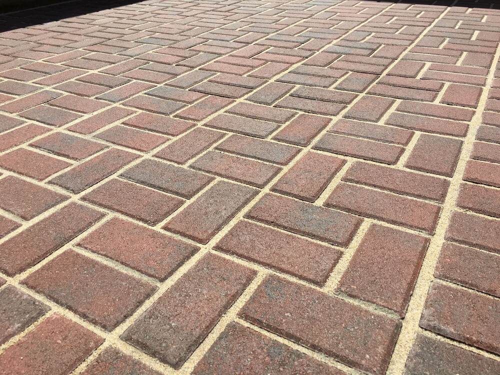 Pattern of Red Pavers With Sand.