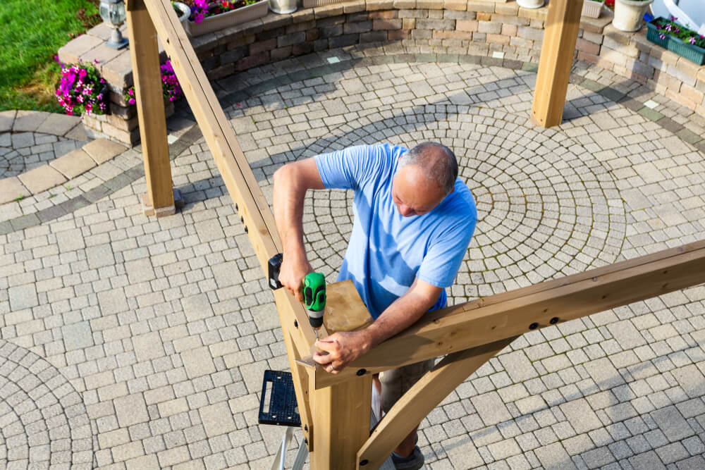Man Building a Wooden Pergola