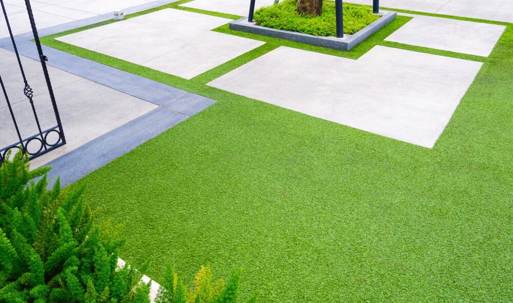 Artificial Turf With Gravel Stone Pavement Decoration And Green Plant In Home Gardening Are