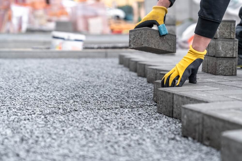 laying interlocking pavers during the construction of sidewalks and roads. copy space