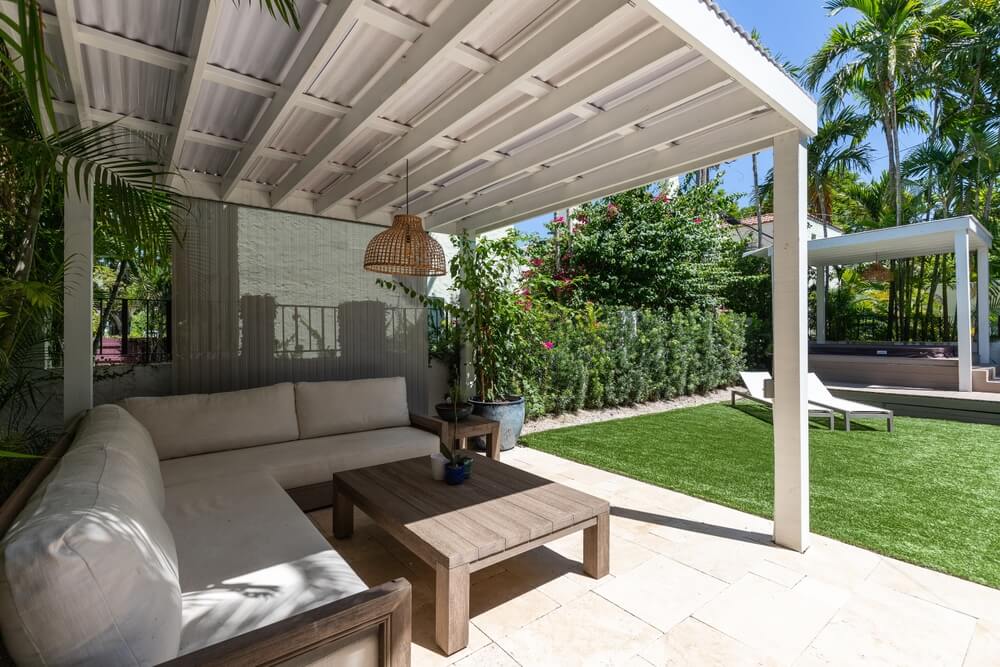 Covered patio with outdoor furniture.