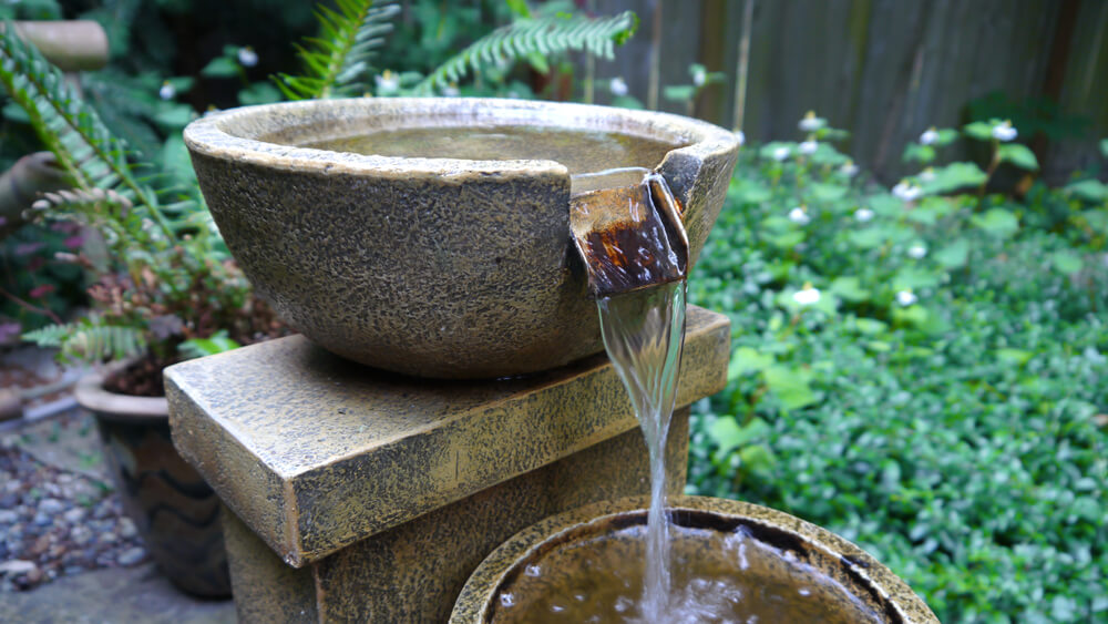 Fountain in a backyard of a home, close up.